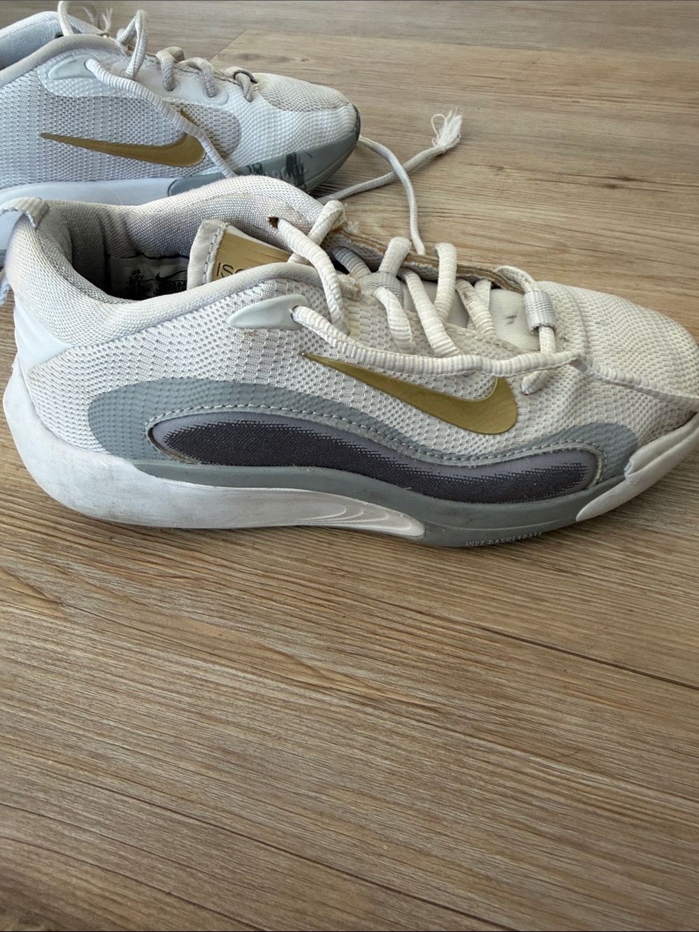 Nike Kids White Sneakers with Gold Swoosh and Gray Accents